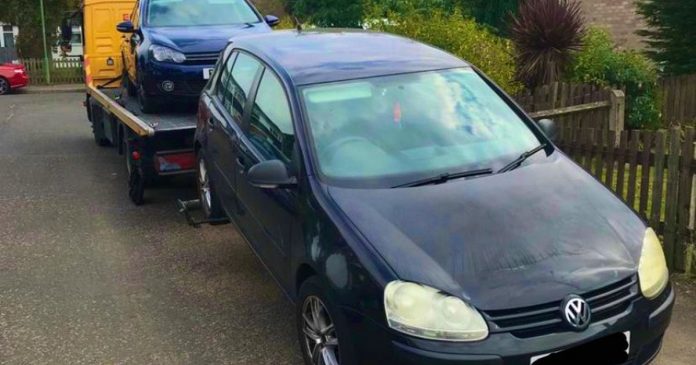 Two vehicles parked together with cloned license plates

