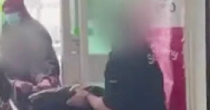 Moment Asda security 'pull woman with pushchair filled with bottles' into store
