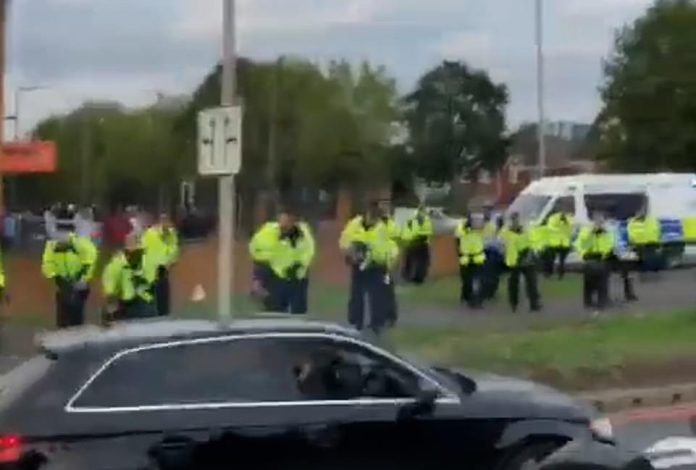 Pictured: Violence between Muslims and Hindus spread from Leicester to Birmingham last night after 200 masked young men believed to be Muslims gathered outside a Hindu temple to protest against an event which had been cancelled